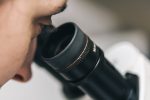 scientist-looking-through-microscope